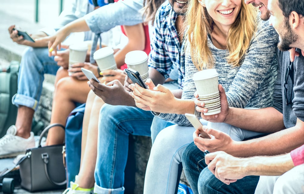 Millenial Friends Group Using Smartphone with Coffee at Universi
